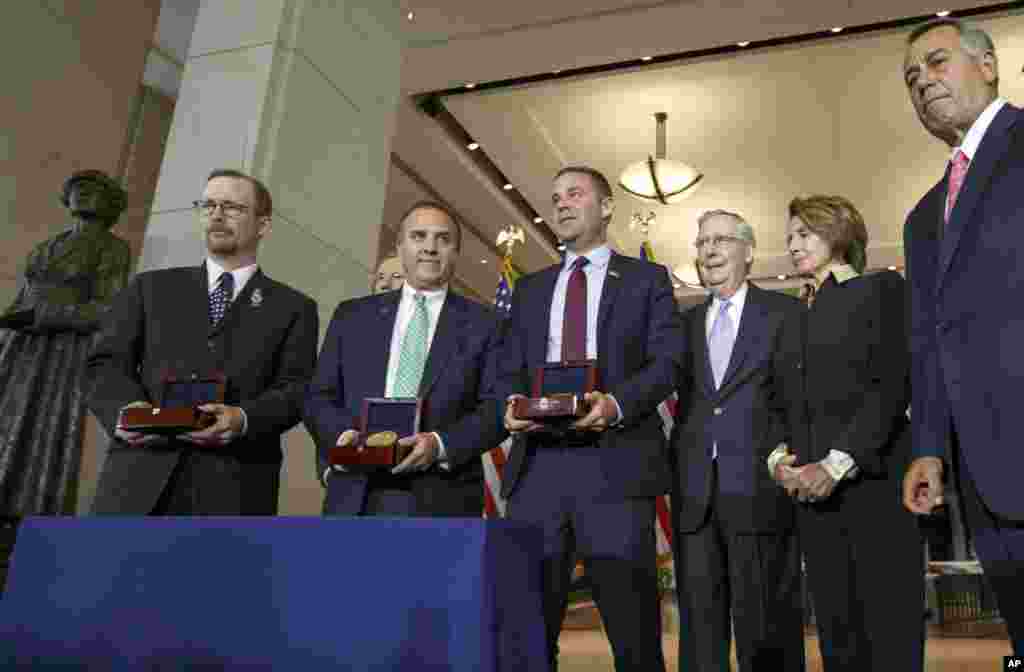 From left, Gordon W. Felt, president, Families of Flight 93 (in the back) James J. Laychak, president, Pentagon Memorial Fund, Joseph C. Daniels, president & CEO, National September 11 Memorial and Museum, and Congressional members stand in honor of the victims of the terror attack of September 11, 2014.