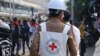 FILE - A Red Cross worker is seen amid protesters against the military coup, in Dawei, Myanmar, Feb. 28, 2021, in this photo obtained from social media. (Dawei Watch/via Reuters) 