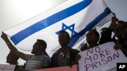 Asylum-seekers march during a protest outside Israeli Prison Saharonim, in Negev desert, southern Israel, Feb. 22, 2018. 