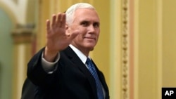 Vice President Mike Pence waves as he walks on Capitol Hill in Washington, Jan. 3, 2018.
