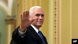 FILE - Vice President Mike Pence waves as he walks on Capitol Hill in Washington, Jan. 3, 2018.