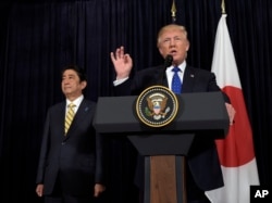 President Donald Trump speaks as Japanese Prime Minister Shinzo Abe listens as they both made statements about North Korea at Mar-a-Lago in Palm Beach, Fla., Feb. 11, 2017.