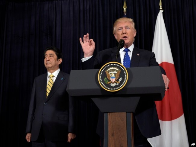 President Donald Trump speaks as Japanese Prime Minister Shinzo Abe listens as they both made statements about North Korea at Mar-a-Lago in Palm Beach, Fla., Feb. 11, 2017.