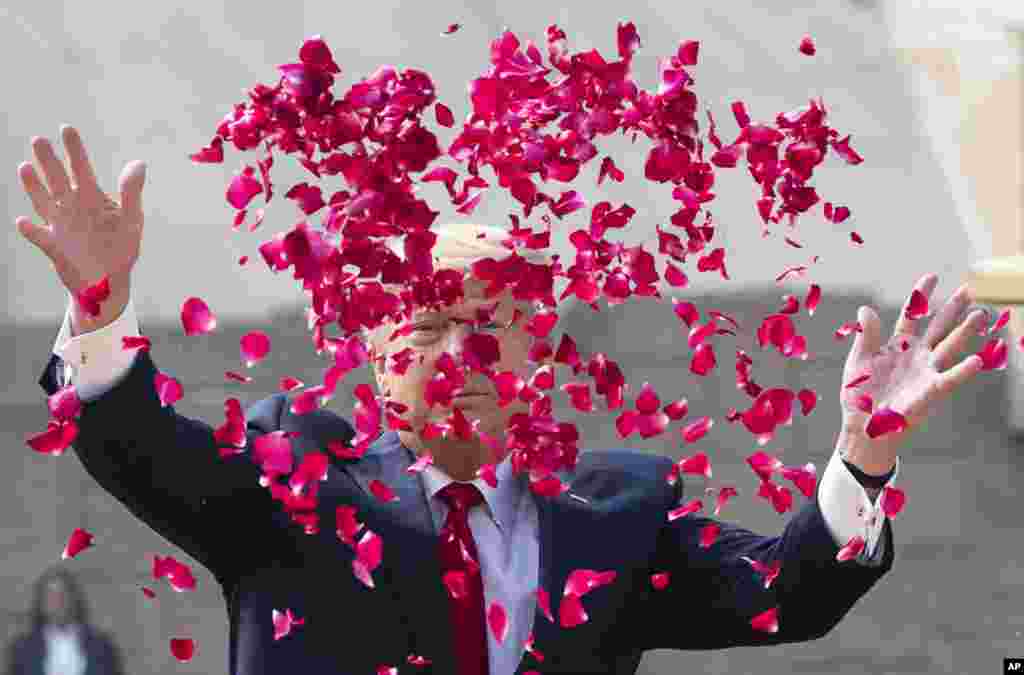 U.S. President Donald Trump offers floral respects at Raj Ghat, the memorial for Mahatma Gandhi, in New Delhi, India.