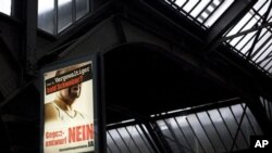 A campaign poster at a train station in Zurich reads 'Ivan S, rapist and soon to be Swiss?', 28 Nov 2010