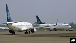 Garuda Indonesia jets taxi at Soekarno-Hatta International Airport in Jakarta, Indonesia, Wednesday, July 15, 2009. Four Indonesian airlines, including Garuda, the country's flag carrier, were removed on Tuesday from an EU list of airlines banned from fly