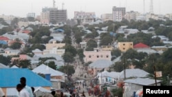 FILE - People walk along a street in Mogadishu, Sept. 28, 2013. 