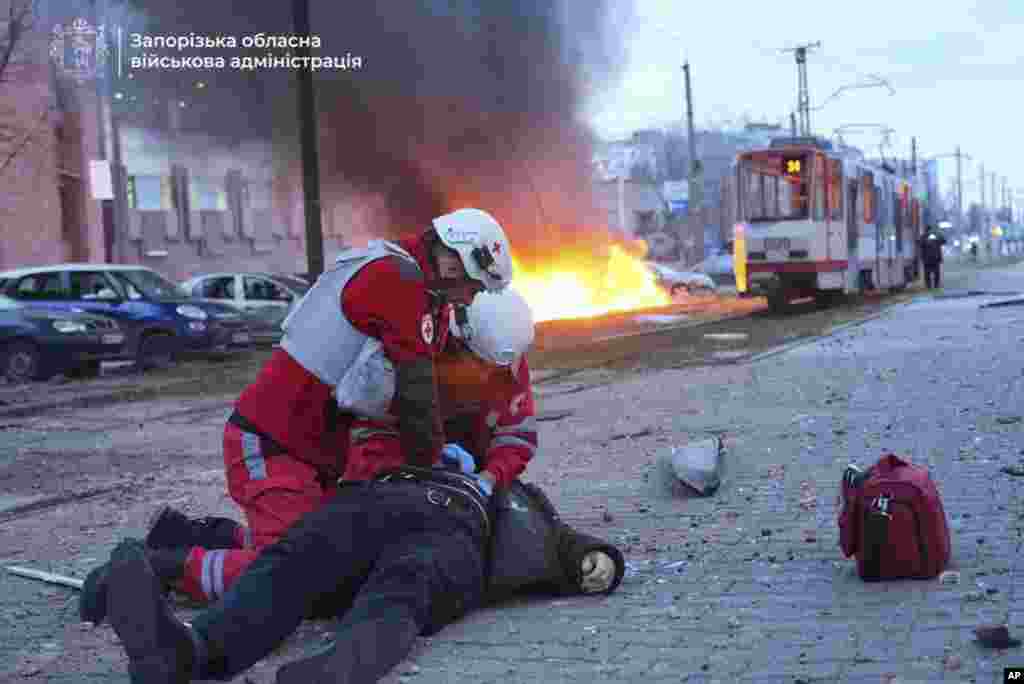 In this photo provided by the Zaporizhzhia regional military administration, paramedics work to resuscitate a man injured in a Russian airstrike in Zaporizhzhia, Ukraine. (Zaporizhzhia regional military administration via AP)