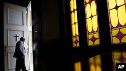 FILE - A parishioner at First Baptist Church, a predominantly African-American congregation, leaves after a worship service in Macon, Ga, July 10, 2016.