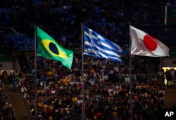 Rio Olympics Closing Ceremony: The flags of Brazil, Greece and Japan fly during the closing ceremony for the Summer Olympics inside Maracana stadium in Rio de Janeiro, Brazil, Sunday, Aug. 21, 2016.