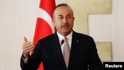 Turkey's Foreign Minister Mevlut Cavusoglu talks at a news conference during a visit in the Turkish Cypriot northern part of the divided city of Nicosia, Cyprus, July 24, 2018.