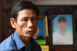 FILE - Nguyen Gia, father of the late 20-year-old Nguyen Dinh Luong who was among 39 people found dead in a truck in Britain last year, in his house in Can Loc district of Vietnam's Ha Tinh province, Oct. 11, 2020.