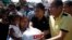 Philippine President Benigno Aquino (R) distributes disaster relief items to survivors of Typhoon Haiyan during his visit to Palo, Leyte province, central Philippines Nov. 18, 2013. 