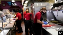FILE: Employees work at a restaurant in Chicago, Thursday, March 23, 2023. On Friday, April 7, the U.S. government issued the March jobs report showing 236,000 new hires. 