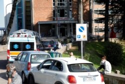 People wait next to their cars outside the Cotugno hospital as the battle with the coronavirus disease (COVID-19) intensifies, in Naples, Italy, Nov. 9, 2020.