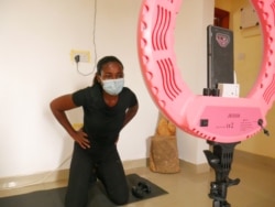 Maabena Antwi used to run popular boot camps for women in Accra; now she does training sessions with them through her phone, from her apartment in Accra, Ghana, July 1, 2020. (Stacey Knott/VOA)