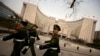 Chinese paramilitary police march past China's central bank, the People's Bank of China, in Beijing, Saturday, March 12, 2016. In a new effort to dispel anxiety about China's cooling economy, the central bank governor said Saturday the country can hit thi