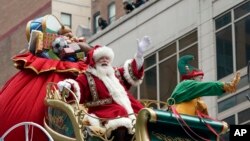 Santa Claus waves from atop a float while riding along 6th Ave. during the Macy's Thanksgiving Day Parade, Nov. 25, 2021, in New York.