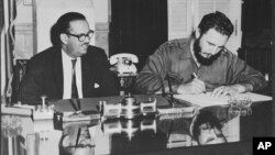 Cuban dictator Fidel Castro signs an order to take over all American-owned banks in Cuba, Sept. 17, 1960.