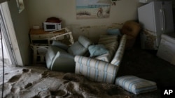 Dozens of centimeters of sand fill a condo following the passage of Hurricane Milton, at YCA Vacation Rental in Venice, Fla., Oct. 11, 2024. 