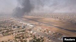 FILE PHOTO: Smoke rises over the city as army and paramilitaries clash in power struggle, in Khartoum