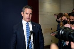FILE - Congressman Adam Kinzinger, a Republican from Illinois, speaks to reporters at the Capitol in Washington, May 12, 2021.