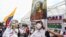 A man holds an image of Jesus during a silent march to support the unblocking of the city's main entrance and exit roads that have been blocked by anti-government protests in Cali, Colombia, Tuesday, May 25, 2021. Colombians have taken to the…