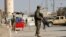 FILE - Afghan National Army (ANA) soldiers keep watch outside the Bagram Airfield entrance gate, after an explosion at the NATO air base, north of Kabul, Nov. 12, 2016. 