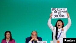 FILE -— Licypriya Kangujam, an Indigenous climate activist from India, holds a banner during the United Nations Climate Change Conference (COP28) in Dubai, United Arab Emirates, December 11, 2023. 