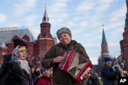 Men play accordions during a folk performance just off Red Square in Moscow, Russia.