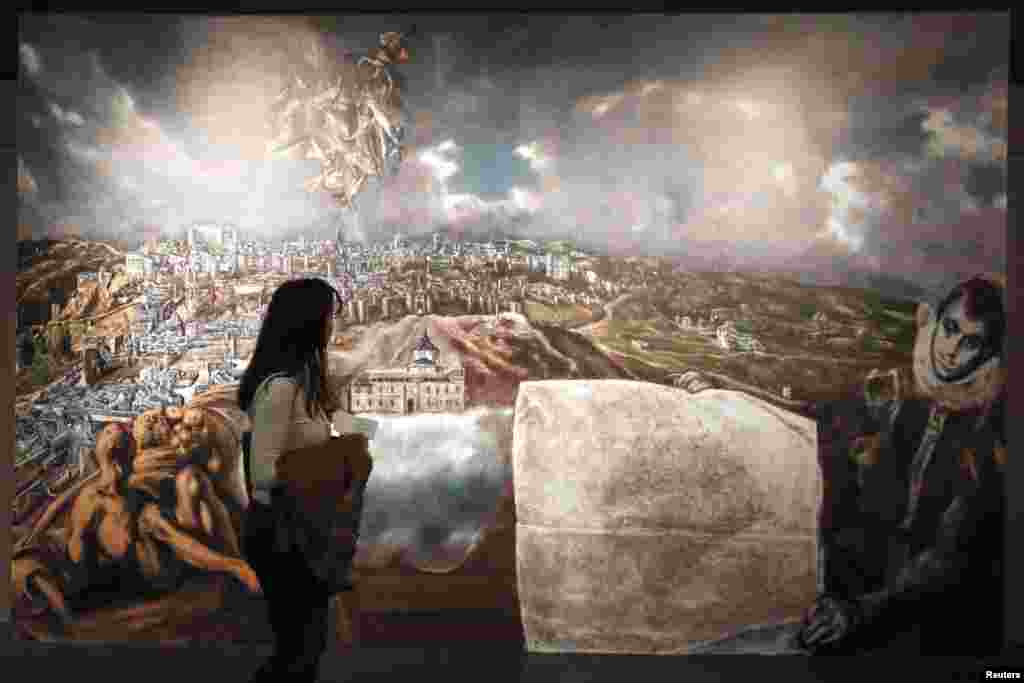 A visitor looks at a digital reproduction of El Greco's "View and Plan of Toledo with map" during the exhibition "Friends and patrons of El Greco in Toledo" at the Benaki museum in Athens.