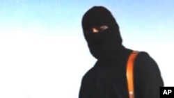 FILE - An undated video released in August shows U.S. journalist Steven Sotloff with an Islamic State militant later dubbed "Jihadi John." Sotloff’s beheading was confirmed in early September. 