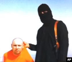 FILE - This image from an undated video released by Islamic State militants Aug. 19, 2014, purports to show journalist Steven Sotloff, who had been captured in Aleppo, being held by the militant group. He was later beheaded.