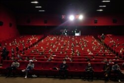 Parisians wait for the early first cinema screening and one year delay premiere of 'Mandibules' by French director Quentin Dupieux in Paris, May, 19, 2021.