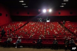 Parisians wait for the early first cinema screening and one year delay premiere of 'Mandibules' by French director Quentin Dupieux in Paris, May, 19, 2021.
