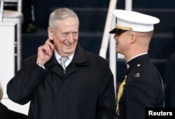 FILE - Retired U.S. Marine Corps General and defense secretary-nominee James Mattis speaks with a Marine guard before the Inaugural parade in Washington, Jan. 20, 2017.