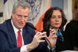 FILE - Mayor Bill de Blasio, left, with Dr. Oxiris Barbot, commissioner of the New York City Department of Health and Mental Hygiene, reports on the city's preparedness for the potential spread of the coronavirus, February 26, 2020.