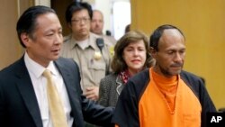 FILE - Jose Ines Garcia Zarate, right, is led into the courtroom by San Francisco Public Defender Jeff Adachi, left, and Assistant District Attorney Diana Garciaor, center, for his arraignment at the Hall of Justice in San Francisco, July 5, 2015.