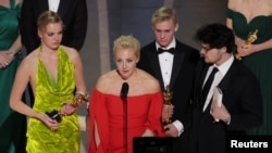 Yulia Navalny, wife of jailed dissident Alexei Navalny, speaks next to her daughter Daria and director Daniel Roher after "Navalny" was awarded for Best Documentary Feature Film during the Oscars show at the 95th Academy Awards in Hollywood, Los Angeles, California, U.S., March 12, 2023.