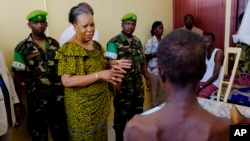FILE - Central African Republic interim President Catherine Samba Panza visits battle victims at the general hospital in Bangui, June 1, 2014. 
