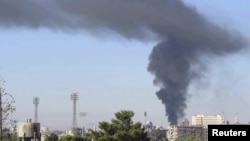 Black smoke billows after a bomb exploded at a military site near a hotel used by United Nations monitors in Damascus, Syria, August 15, 2012.