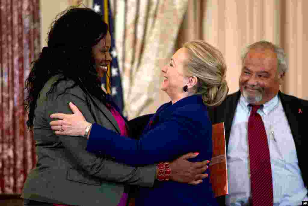 Secretary of State Hillary Clinton greets Florence Ngobeni-Allen, ambassador for the Elizabeth Glaser Pediatric AIDS Foundation, November 29, 2012, during a ceremony in recognition of World AIDS Day.