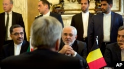FILE - Iranian Foreign Minister Jawad Zarif (C-R) speaks with Belgian Foreign Minister Didier Reynders during a meeting in Brussels on Jan. 11, 2018, amid doubts over the future of an international agreement curbing Iran's nuclear ambitions.