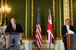 Mike Pompeo (L) speaks during a meeting with Britain's Foreign Secretary Dominic Raab