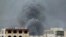 Smoke billows following an airstrike by the Saudi-led coalition on the headquarters of the Special Security Forces, formerly known as the Central Security, in Sana'a, Yemen, May 27, 2015.