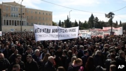 People gather during a protest outside the Greek parliament, in Athens, Greece, March 5, 2023. 