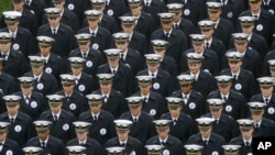 FILE - Navy midshipmen march onto field ahead of an NCAA college football game between the Army and the Navy in Philadelphia, Dec. 14, 2019.