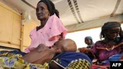 FILE - Mothers and their malnourished children at an intensive nutritional rehabilitation center in Tanout, southern Niger, April 27, 2010.