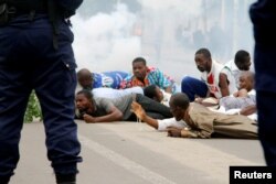 Riot policemen fire teargas canisters to disperse demonstrators during a protest organised by Catholic activists in Kinshasa, DRC, Jan. 21, 2018.