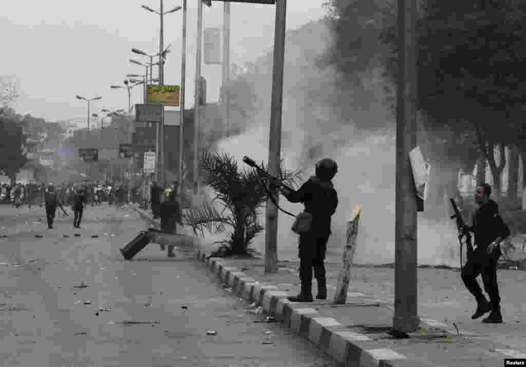 Egyptian security forces fire tear gas during clashes with supporters of ousted President Mohamed Morsi around the Qubba Palace in Cairo, Nov. 29, 2013.